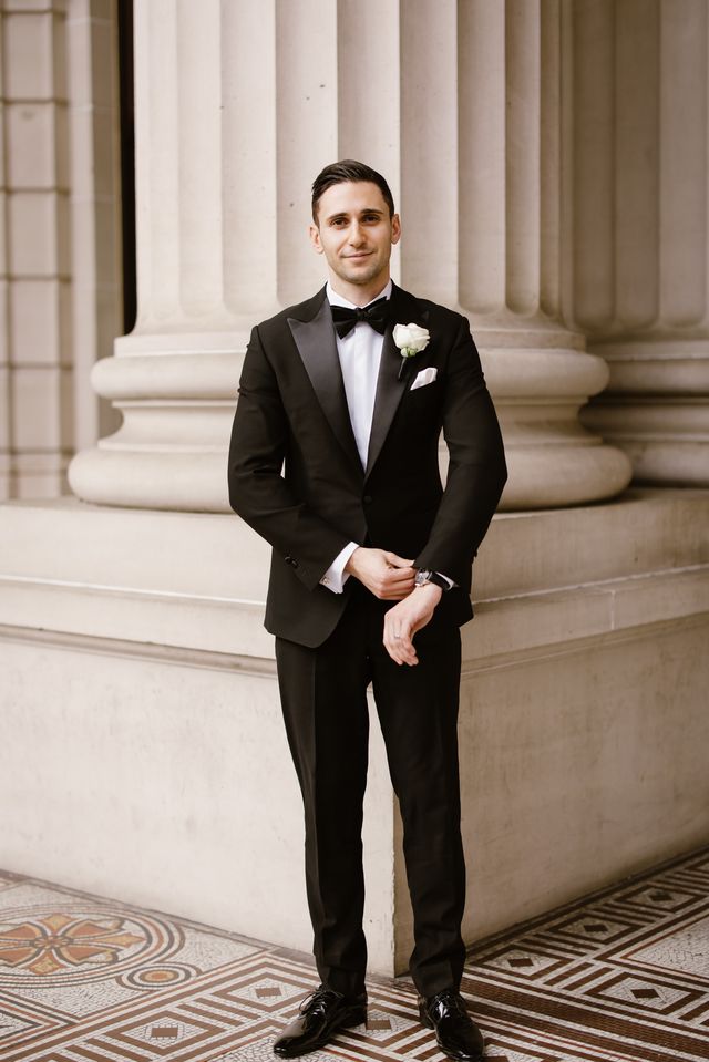 Groom in a classic black peak-lapel tuxedo