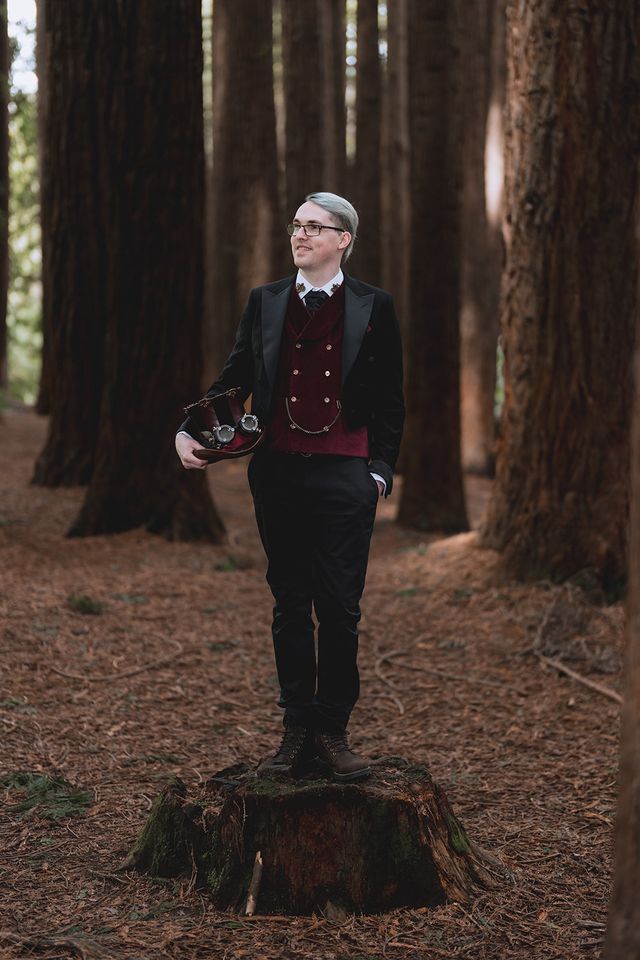 Groom in a black tailcoat with a burgundy velvet waistcoat