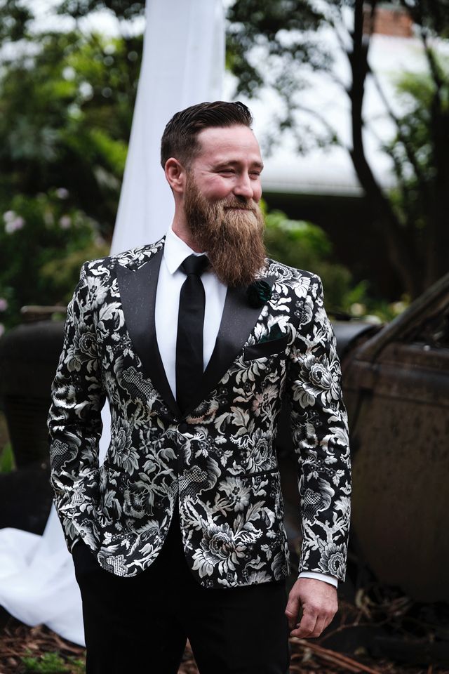 Groom in a black-and-white floral brocade dinner jacket