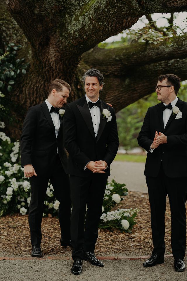 Groom and groomsmen in black tuxedos