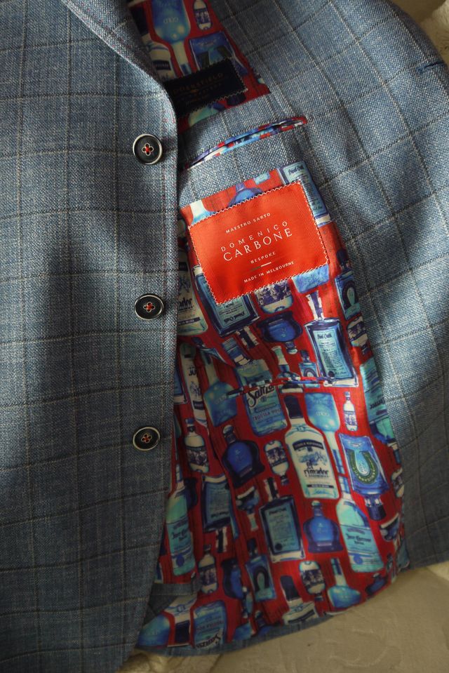 Blue windowpane-check jacket with a bottle-print lining