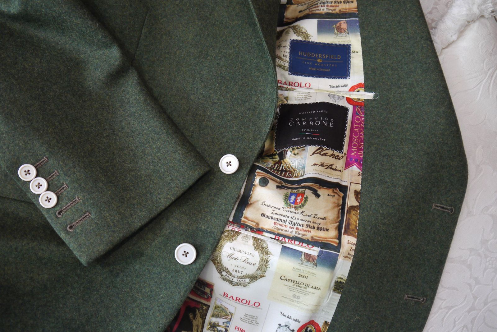 Olive-green jacket with a wine-label print lining