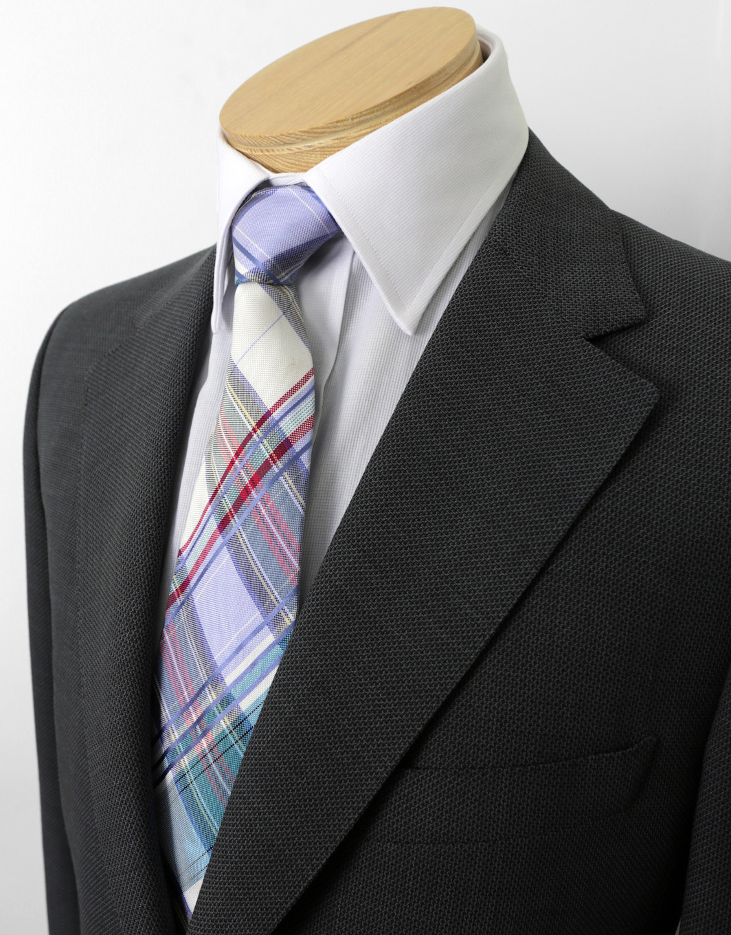Charcoal business suit with a plaid tie