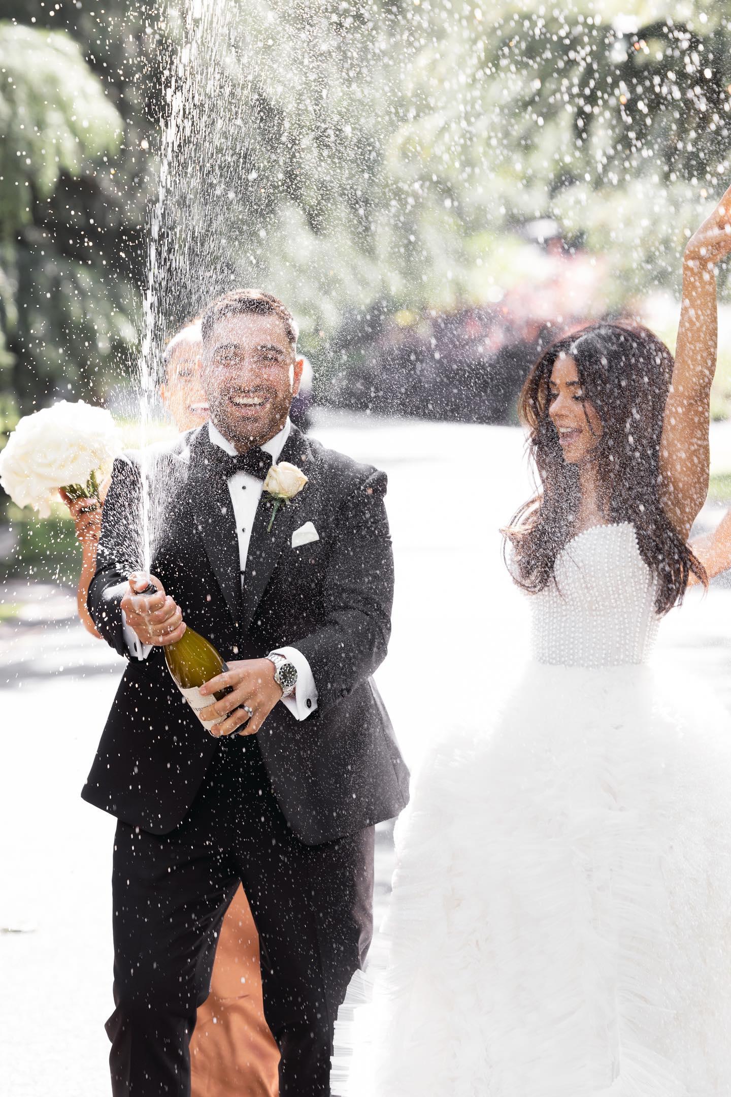 Groom in a black tuxedo with the bride